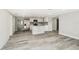 Open-concept kitchen and living room featuring an island with marble countertop and stainless steel appliances at 10831 Manchester Rd, Port Richey, FL 34668