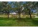 Lush backyard with mature trees lining the canal, perfect for enjoying the outdoors at 10921 Cory Lake Dr, Tampa, FL 33647