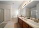 Bright bathroom with double sinks, soaking tub, and separate shower at 10921 Cory Lake Dr, Tampa, FL 33647
