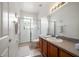 Modern bathroom with a glass-enclosed shower, granite vanity, and neutral tile floors at 10921 Cory Lake Dr, Tampa, FL 33647