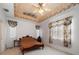 Bedroom featuring a decorative ceiling, carpet and ample natural light from two windows at 10921 Cory Lake Dr, Tampa, FL 33647