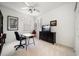 Bright bedroom with desk, TV on cabinet, ceiling fan, and neutral carpet at 10921 Cory Lake Dr, Tampa, FL 33647