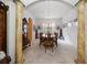 Bright dining room featuring an oval dining table, columns, and a decorative light fixture at 10921 Cory Lake Dr, Tampa, FL 33647