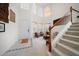 Bright entryway with high ceilings, a chandelier, and staircase with wood trim at 10921 Cory Lake Dr, Tampa, FL 33647
