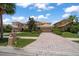 Charming two-story home featuring a tile roof, brick driveway, and well-manicured landscaping at 10921 Cory Lake Dr, Tampa, FL 33647