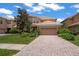Charming two-story home featuring a tile roof, manicured landscaping, and an attached two-car garage at 10921 Cory Lake Dr, Tampa, FL 33647