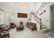 Bright living room with high ceilings, a chandelier, and staircase with wood trim at 10921 Cory Lake Dr, Tampa, FL 33647