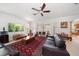 Open living room with neutral carpet, a ceiling fan, and large windows for natural light at 10921 Cory Lake Dr, Tampa, FL 33647