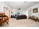 Open living room with neutral carpet, a ceiling fan, and large windows for natural light at 10921 Cory Lake Dr, Tampa, FL 33647