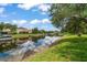 Picturesque waterfront view with boats docked along the canal and blue sky reflections at 10921 Cory Lake Dr, Tampa, FL 33647