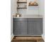 Elegant bar area featuring custom gray cabinetry, countertop, and open shelving perfect for entertaining guests at 1108 N Franklin St # 602, Tampa, FL 33602