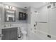 Stylish bathroom featuring a gray vanity, marble countertop, subway tile, and a glass-enclosed tub-shower combo at 1108 N Franklin St # 602, Tampa, FL 33602