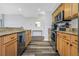 Kitchen with stainless appliances, granite counters, wood cabinets, and wood-look floors at 1108 N Franklin St # 602, Tampa, FL 33602