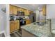 Well-lit kitchen features granite countertops, stainless steel appliances, and wood cabinets at 1108 N Franklin St # 602, Tampa, FL 33602