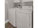 Functional laundry area with white, front-loading washer and dryer appliances for convenient laundry tasks at 1108 N Franklin St # 602, Tampa, FL 33602