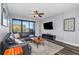 Cozy living room with black leather sofa, mounted TV, city views from a private balcony at 1108 N Franklin St # 602, Tampa, FL 33602