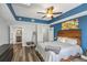 Bedroom with wood-look floors, ceiling fan, and ensuite bathroom at 1108 N Franklin St # 602, Tampa, FL 33602