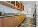 Pantry with wood-look floors, granite counters, and open wood shelving at 1108 N Franklin St # 602, Tampa, FL 33602