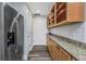 Spacious pantry with granite counters, wood cabinets, and stainless steel refrigerator at 1108 N Franklin St # 602, Tampa, FL 33602