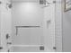 Modern tiled shower with glass enclosure, brushed nickel fixtures, and built-in niche for toiletries at 1108 N Franklin St # 602, Tampa, FL 33602