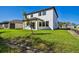 Spacious backyard featuring lush lawn and a two-story home exterior at 11311 Striped Bass Ct, New Port Richey, FL 34654
