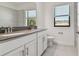 Bright bathroom with double vanity, sleek fixtures, and a window offering natural light at 11311 Striped Bass Ct, New Port Richey, FL 34654