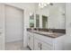 Well-lit bathroom with a double vanity, modern fixtures, and a view into the next room at 11311 Striped Bass Ct, New Port Richey, FL 34654