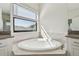 Large soaking tub in a bathroom with a window for natural light at 11311 Striped Bass Ct, New Port Richey, FL 34654