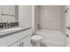 Bathroom featuring a vanity with a gray countertop, a toilet, and a tiled shower-tub combo at 11311 Striped Bass Ct, New Port Richey, FL 34654