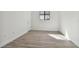Bright bedroom with light-colored floors, a black-framed window, and a minimalist aesthetic at 11311 Striped Bass Ct, New Port Richey, FL 34654