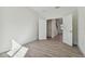Minimalist bedroom with light-colored floors and a view of the hallway through open double doors at 11311 Striped Bass Ct, New Port Richey, FL 34654