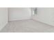 Large carpeted bedroom featuring a bright window for natural light at 11311 Striped Bass Ct, New Port Richey, FL 34654