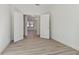 Bedroom featuring light-colored floors with a view of an arched hallway through open double doors at 11311 Striped Bass Ct, New Port Richey, FL 34654