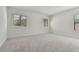 Large carpeted bedroom features bright windows for natural light at 11311 Striped Bass Ct, New Port Richey, FL 34654