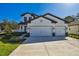 Beautiful two-story home featuring a three car garage and manicured front lawn at 11311 Striped Bass Ct, New Port Richey, FL 34654