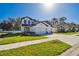 Charming two-story home with a large driveway and well-maintained green lawn at 11311 Striped Bass Ct, New Port Richey, FL 34654