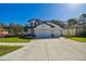 Lovely two-story home with a three car garage, featuring a manicured lawn at 11311 Striped Bass Ct, New Port Richey, FL 34654