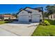 Beautiful two-story home featuring a three car garage and manicured front lawn at 11311 Striped Bass Ct, New Port Richey, FL 34654