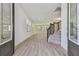 Elegant foyer with wood-look floors, staircase, and decorative front door at 11311 Striped Bass Ct, New Port Richey, FL 34654