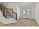 Welcoming foyer with decorative glass doors, staircase, and wood-look flooring at 11311 Striped Bass Ct, New Port Richey, FL 34654