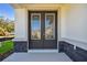 Inviting double doors with decorative glass inserts and stone detailing at 11311 Striped Bass Ct, New Port Richey, FL 34654