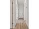 Bright hallway with light wood-look flooring and white trim and doors create an open and inviting space at 11311 Striped Bass Ct, New Port Richey, FL 34654