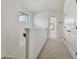 Second-floor hallway with light-colored carpet, a black-framed window, and closed double doors at 11311 Striped Bass Ct, New Port Richey, FL 34654
