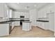 Bright kitchen featuring white cabinets, stainless steel appliances, and a center island at 11311 Striped Bass Ct, New Port Richey, FL 34654