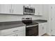 A close-up shot of a stainless steel oven and microwave in the kitchen area at 11311 Striped Bass Ct, New Port Richey, FL 34654