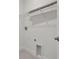 Laundry room features overhead wire shelf, base molding and hookups for washer and dryer at 11311 Striped Bass Ct, New Port Richey, FL 34654