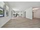 Bright and airy living room featuring wood floors, recessed lighting, and an archway to the dining room at 11311 Striped Bass Ct, New Port Richey, FL 34654