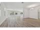 Open-concept living area with neutral walls, hardwood floors, and natural light at 11311 Striped Bass Ct, New Port Richey, FL 34654