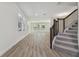 Bright living room featuring wood floors and a staircase at 11311 Striped Bass Ct, New Port Richey, FL 34654