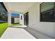 Covered patio with sliding glass doors and a view of the manicured lawn at 11311 Striped Bass Ct, New Port Richey, FL 34654